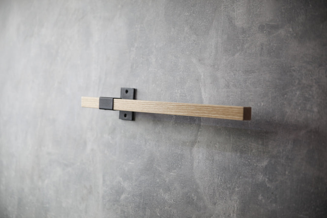 elegant-storage-solution-with-a-wooden-rail-perfect-for-towels