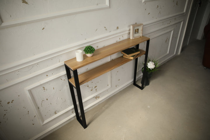 Slim-wood-and-metal-console-table-placed-along-a-hallway-wall