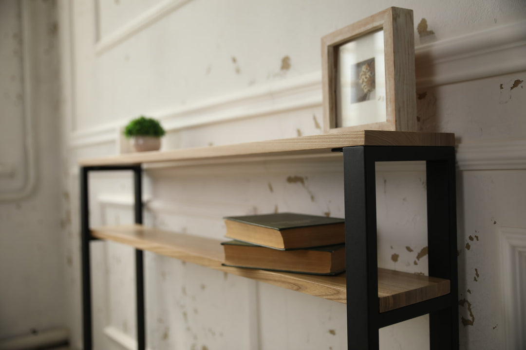 Slim-wood-and-metal-console-table-placed-along-a-hallway-wall