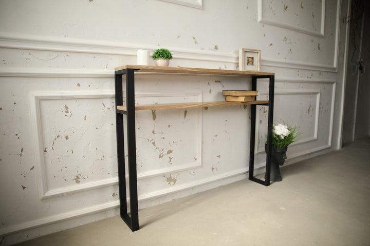 Slim-wood-and-metal-console-table-placed-along-a-hallway-wall