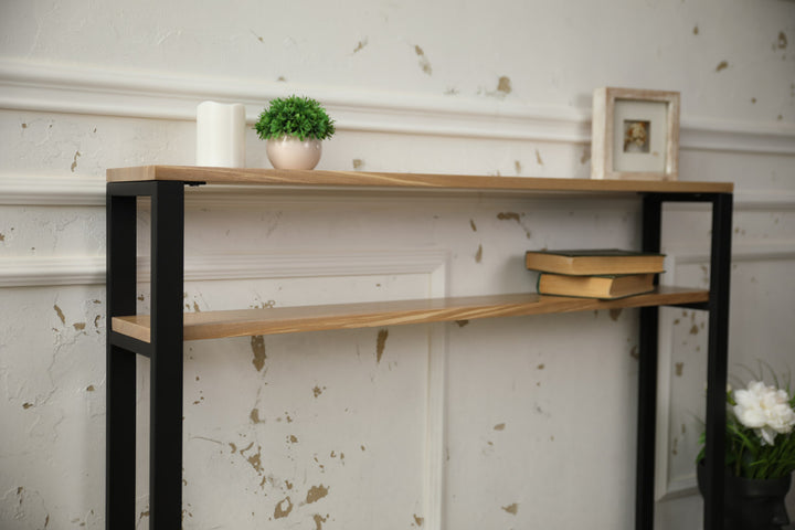 Slim-wood-and-metal-console-table-placed-along-a-hallway-wall