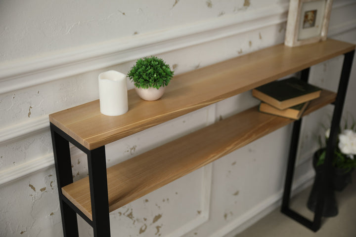 Slim-wood-and-metal-console-table-placed-along-a-hallway-wall