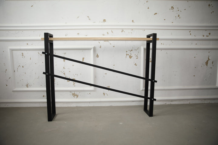 slim-wood-and-metal-console-table-placed-along-a-hallway-wall