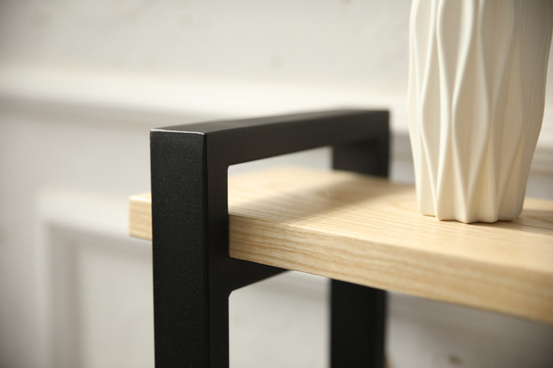 slim-wood-and-metal-console-table-placed-along-a-hallway-wall