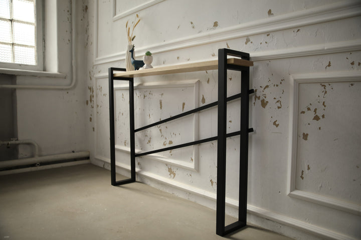 slim-wood-and-metal-console-table-placed-along-a-hallway-wall