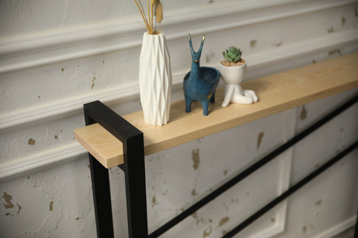 slim-wood-and-metal-console-table-placed-along-a-hallway-wall