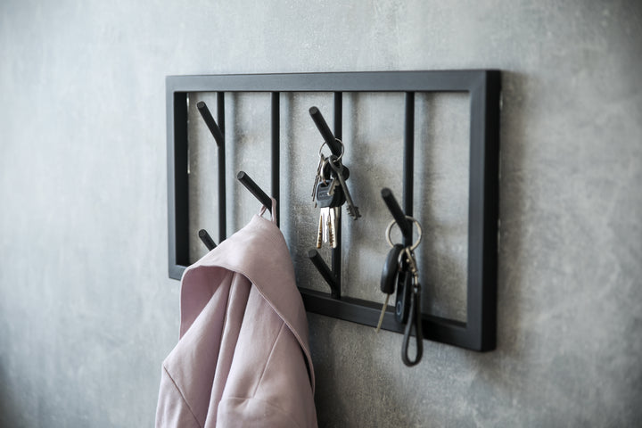 Modern-black-metal-wall-mounted-coat-rack-with-a-minimalist-tree-branch-design-Perfect-for-organizing-coats-hats-and-accessories-in-a-stylish-way