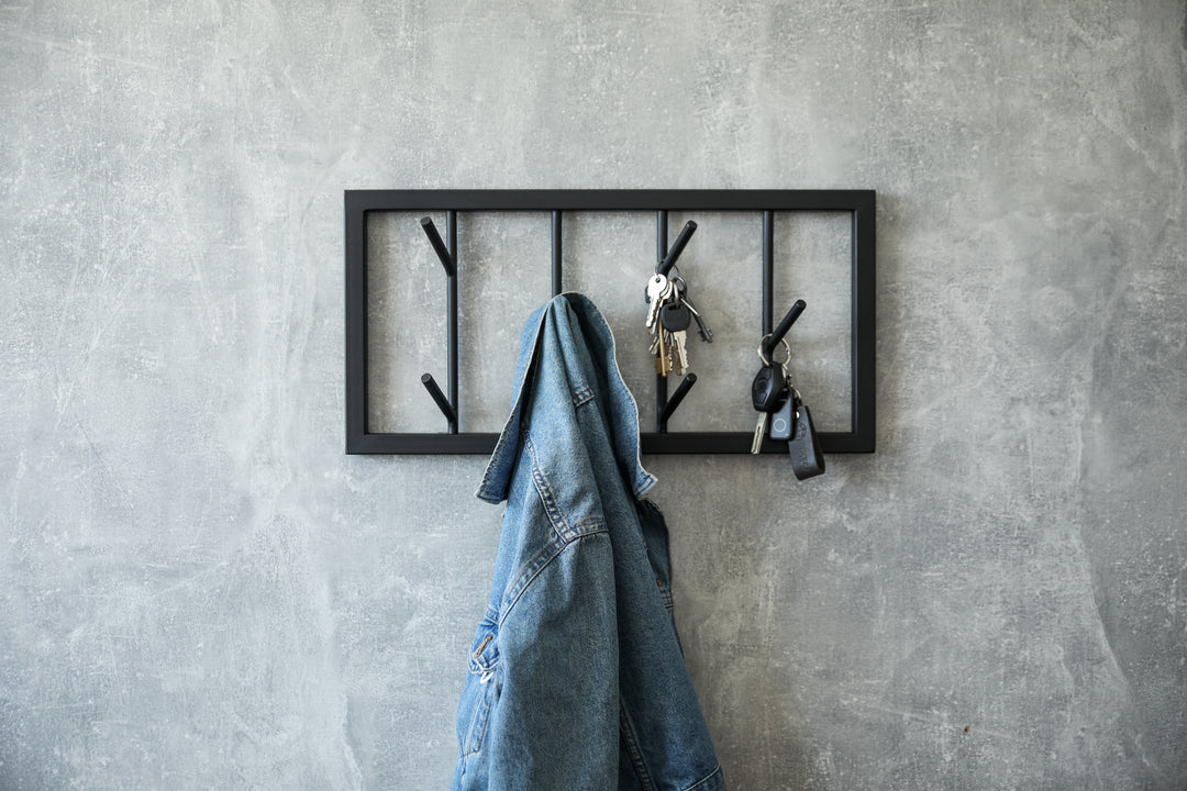 Modern-black-metal-wall-mounted-coat-rack-with-a-minimalist-tree-branch-design-Perfect-for-organizing-coats-hats-and-accessories-in-a-stylish-way