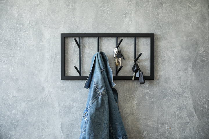 Modern-black-metal-wall-mounted-coat-rack-with-a-minimalist-tree-branch-design-Perfect-for-organizing-coats-hats-and-accessories-in-a-stylish-way