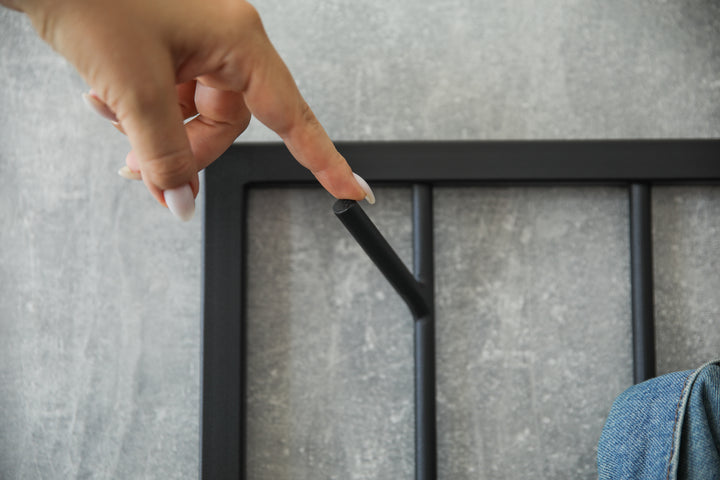 Modern-black-metal-wall-mounted-coat-rack-with-a-minimalist-tree-branch-design-Perfect-for-organizing-coats-hats-and-accessories-in-a-stylish-way