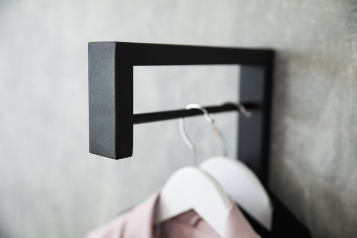 Contemporary-wall-mounted-clothes-hanger-with-a-practical-design
